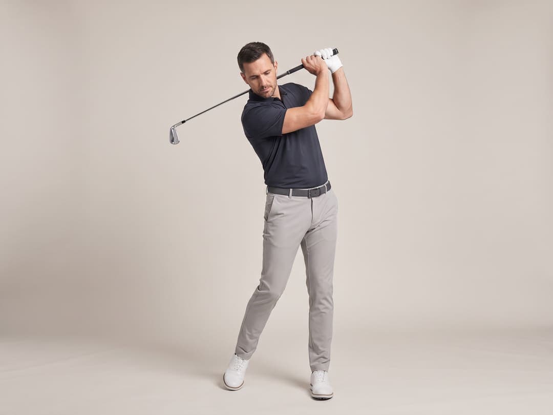 Drill footage: a golfer holding a position in the backswing.